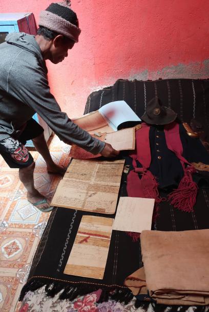 A Timorese man arranging manuscripts 