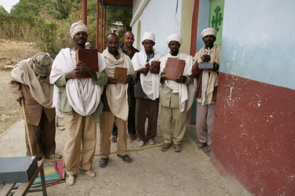 Local priests, members of the community, and the representative of the Tigray Culture and Tourism Agency