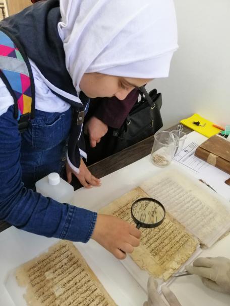 School girl inspecting one of the manuscripts